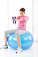 Fitness woman exercise dumbbell ball gym