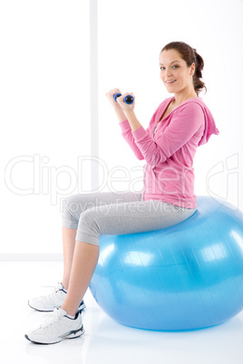 Fitness woman exercise dumbbell ball gym