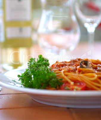 Spaghetti with a tomato sauce on a table in cafe