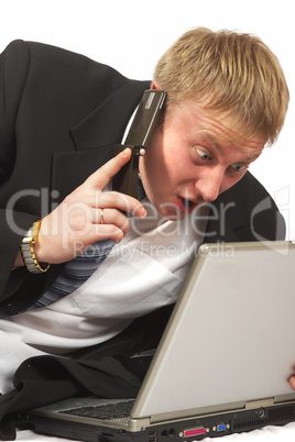 The businessman with phone looks in laptop. Tests a shock and su