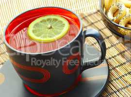 Cup of tea with a lemon on a table