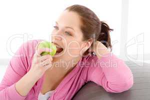 Fitness woman eat apple sportive outfit