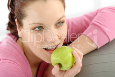 Fitness woman eat apple sportive outfit