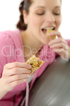 Fitness woman eat granola sportive outfit happy