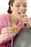 Fitness woman eat granola sportive outfit happy