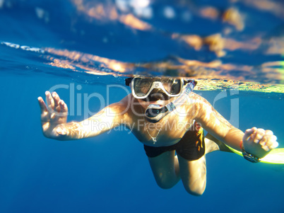 boy floats under water