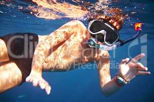 boy floats under water