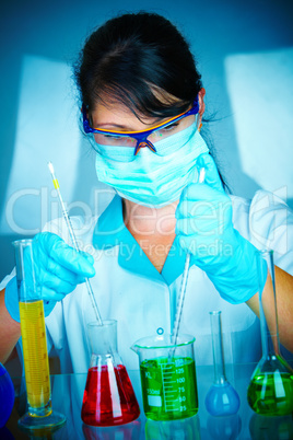 scientist in laboratory with test tubes