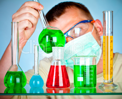 Young scientist in laboratory with test tubes