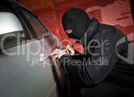 robber and the thief in a mask hijacks the car