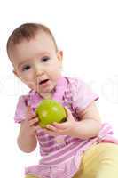 Baby girl in pink eating apple