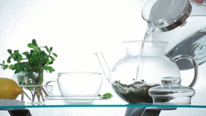 TL Woman preparing herbal chinese tea