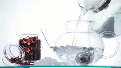 Woman preparing red Hibiscus tea