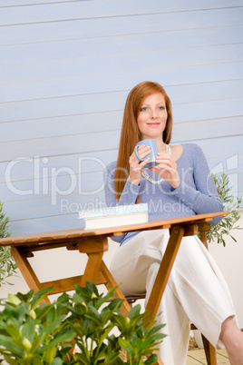 Summer terrace redhead woman relax in garden