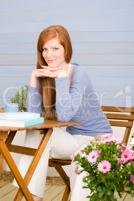 Summer terrace redhead woman relax in garden Summer terrace redhead woman relax in garden