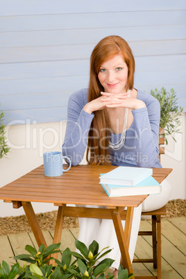 Summer terrace redhead woman relax in garden