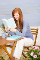 Summer terrace redhead woman read book