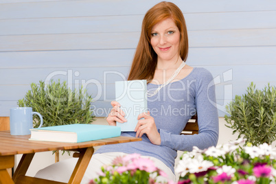 Summer terrace redhead woman relax in garden