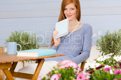 Summer terrace redhead woman relax in garden