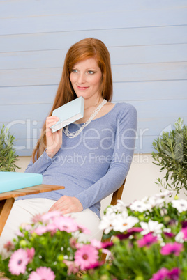 Summer terrace redhead woman relax in garden