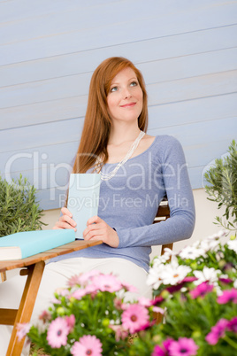 Summer terrace redhead woman relax in garden