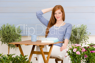 Summer terrace redhead woman relax in garden