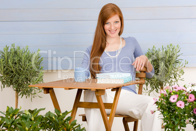 Summer terrace redhead woman relax in garden