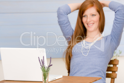 Summer terrace redhead woman with laptop