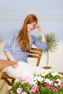 Summer terrace redhead woman relax in garden