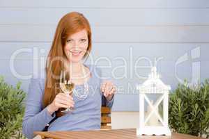 Summer terrace redhead woman with glass of wine