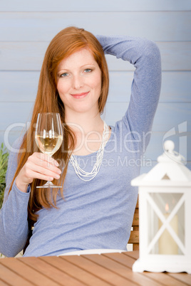 Summer terrace redhead woman hold glass of wine