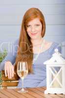 Summer terrace redhead woman with glass of wine