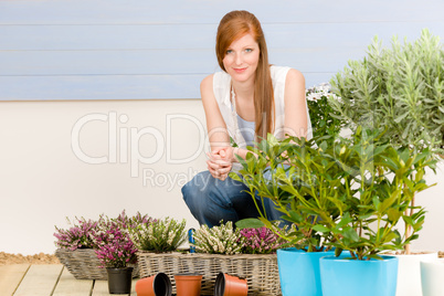 Summer garden terrace redhead woman with flowers