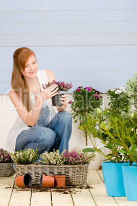 Summer garden terrace redhead woman hold flower