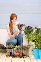 Summer garden terrace redhead woman hold flower