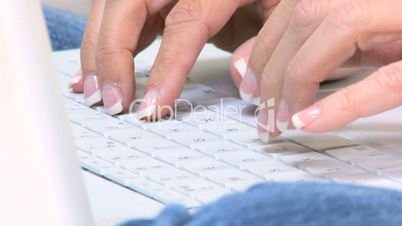 Female Fingers Using a Laptop Keyboard