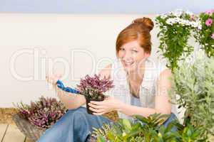 Summer garden terrace redhead woman potted flower