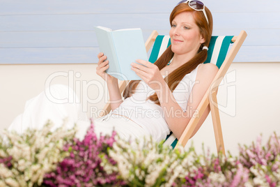 Summer terrace red hair woman relax in deckchair