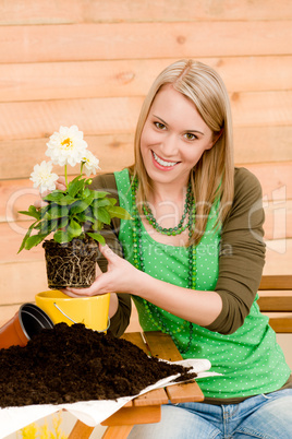 Gardening woman planting spring flower