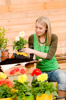 Gardening woman planting spring flower