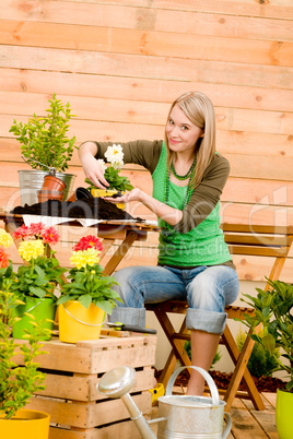 Gardening woman planting spring flower