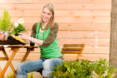 Gardening woman planting spring flower