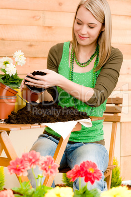 Gardening woman planting spring flower