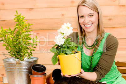 Gardening woman planting spring flower