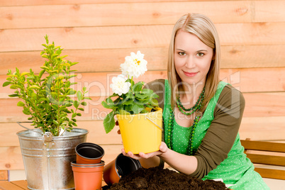 Gardening woman planting spring flower