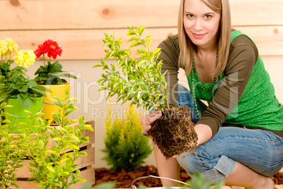 Gardening woman planting on terrace