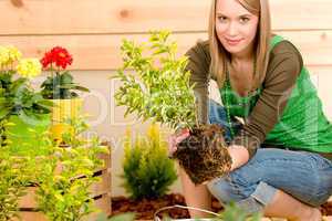 Gardening woman planting on terrace