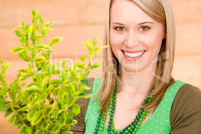 Portrait happy woman hold plant spring gardening