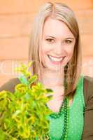 Portrait happy woman hold green plant spring