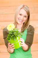 Portrait happy woman with yellow spring flower